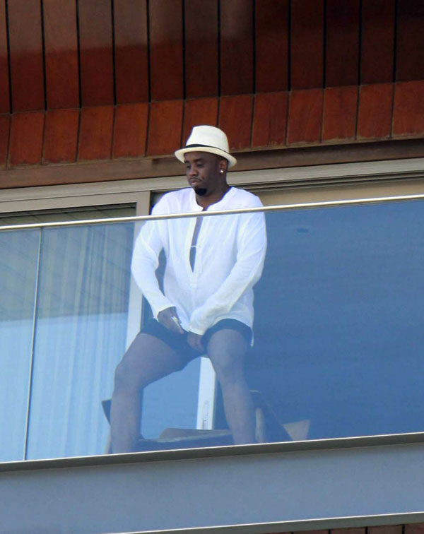 P Diddy on a balconey in Rio. What's he doing?